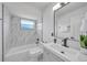Bathroom featuring stylish fixtures and marble-look tile around the tub and shower combo at 2166 Beacon Dr, Port Charlotte, FL 33952