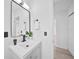 Bathroom features include modern fixtures, light vanity, and stylish rectangular mirror at 2166 Beacon Dr, Port Charlotte, FL 33952