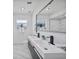 Modern bathroom featuring a double vanity, sleek black fixtures, and tiled floors and walls at 2166 Beacon Dr, Port Charlotte, FL 33952