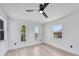 Bright bedroom with wood-look floors, white walls and 3 windows allowing natural light at 2166 Beacon Dr, Port Charlotte, FL 33952