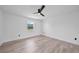 Neutral bedroom with wood-look floors, white walls and one window allowing natural light at 2166 Beacon Dr, Port Charlotte, FL 33952