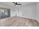 Bright, neutral bedroom with wood-look floors, white walls and a sliding glass door to the outdoors at 2166 Beacon Dr, Port Charlotte, FL 33952