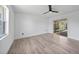 Bright, neutral bedroom with wood-look floors, white walls and a sliding glass door to the outdoors at 2166 Beacon Dr, Port Charlotte, FL 33952
