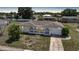 Single-story home with neutral roof, arched entryway, attached garage, and landscaped front yard at 2166 Beacon Dr, Port Charlotte, FL 33952