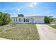 Charming single-story home featuring a well-manicured lawn, arched entryway and attached one car garage at 2166 Beacon Dr, Port Charlotte, FL 33952