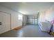 Spacious garage featuring laundry, roll up garage door, side access door, and epoxy floor at 2166 Beacon Dr, Port Charlotte, FL 33952