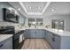 Modern kitchen with gray cabinets, quartz countertops, stainless steel appliances, and a stylish backsplash at 2166 Beacon Dr, Port Charlotte, FL 33952