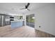 Updated kitchen with grey cabinets, white countertops, stainless steel appliances, and an adjacent living space at 2166 Beacon Dr, Port Charlotte, FL 33952