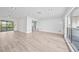 Open floor plan showcasing light wood flooring, recessed lighting, and a seamless flow into the kitchen area at 2166 Beacon Dr, Port Charlotte, FL 33952