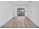 A versatile room boasting light wood flooring, white walls, and sliding glass doors for access to the outdoors at 2166 Beacon Dr, Port Charlotte, FL 33952