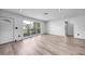 Living room featuring updated flooring, fresh paint, and modern finishes, with a view of the front yard at 2166 Beacon Dr, Port Charlotte, FL 33952