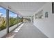 Enclosed patio with screen windows offering views of the lush landscape at 2166 Beacon Dr, Port Charlotte, FL 33952