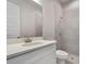 This bathroom has a shower and sink with white cabinets at 223 Australian Dr, Rotonda West, FL 33947