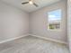 This bedroom offers hard surface floors, ceiling fan and natural light at 223 Australian Dr, Rotonda West, FL 33947
