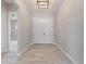 Bright foyer with wood-look tile flooring, a modern light fixture, and a glimpse into the spacious interior at 223 Australian Dr, Rotonda West, FL 33947