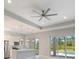Open kitchen with stainless appliances, island with pendant lighting, and natural light from pool view at 223 Australian Dr, Rotonda West, FL 33947