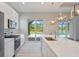 Gourmet kitchen featuring stainless steel appliances, white quartz countertops, and a pool view at 223 Australian Dr, Rotonda West, FL 33947