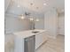 Open concept kitchen with large island, stainless steel appliances, and modern lighting at 223 Australian Dr, Rotonda West, FL 33947