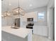 Modern kitchen with stainless steel appliances and white cabinets, pendant lighting at 223 Australian Dr, Rotonda West, FL 33947