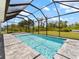 Backyard pool featuring a screened-in enclosure for enjoying the Florida weather at 223 Australian Dr, Rotonda West, FL 33947
