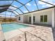Sparkling pool with a screened enclosure and brick patio, offering a refreshing outdoor space at 223 Australian Dr, Rotonda West, FL 33947