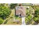 Sprawling home boasts an open layout, screened pool, long driveway and mature landscaping at 2300 Carpenter Ln, North Port, FL 34286