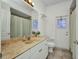 Well-lit bathroom featuring a granite countertop and modern fixtures at 2300 Carpenter Ln, North Port, FL 34286