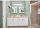 Bathroom featuring double sinks and a glass door shower at 2300 Carpenter Ln, North Port, FL 34286