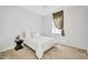 Bright bedroom with neutral carpet and a bed with black nightstand at 2300 Carpenter Ln, North Port, FL 34286