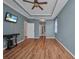 Bedroom with hardwood floors, a ceiling fan, and tv on the wall at 2300 Carpenter Ln, North Port, FL 34286