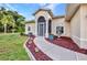 Beautifully landscaped home featuring a manicured lawn and unique plants along the walkway at 2300 Carpenter Ln, North Port, FL 34286