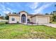 Well-manicured single-Gathering home with a lush front lawn and an attached two-car garage at 2300 Carpenter Ln, North Port, FL 34286