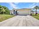 Well-maintained single-Gathering home with a spacious driveway and a lush front yard at 2300 Carpenter Ln, North Port, FL 34286