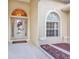 Welcoming front entrance featuring a decorative wreath, arched window, and neutral tones at 2300 Carpenter Ln, North Port, FL 34286