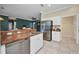 Kitchen featuring stainless steel appliances, tile floors, and a view to the living area at 2300 Carpenter Ln, North Port, FL 34286
