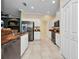 Well-lit kitchen featuring stainless steel appliances, sleek cabinets and tile backsplash at 2300 Carpenter Ln, North Port, FL 34286