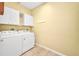 Laundry room featuring white appliances at 2300 Carpenter Ln, North Port, FL 34286