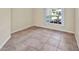 Charming room with ceramic tile flooring, natural light, and white baseboards at 2300 Carpenter Ln, North Port, FL 34286