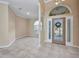 Open-concept living room with tile flooring, arched doorways, and neutral paint tones at 2300 Carpenter Ln, North Port, FL 34286