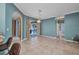 Living room with tile floors, sliding glass doors, and an open floor plan at 2300 Carpenter Ln, North Port, FL 34286