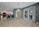 Open concept living room with tile floors, access to the lanai, and kitchen view at 2300 Carpenter Ln, North Port, FL 34286