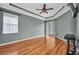 Spacious room featuring hardwood floors, a ceiling fan, and sliding door access to the outdoors at 2300 Carpenter Ln, North Port, FL 34286