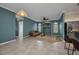 Living room featuring an open layout, tile floors, and views into the kitchen at 2300 Carpenter Ln, North Port, FL 34286