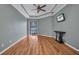 Inviting living room featuring hardwood floors, a ceiling fan, and sliding door access to the pool at 2300 Carpenter Ln, North Port, FL 34286