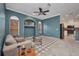 Cozy living room with built-in shelving, tile flooring, and a view to the kitchen at 2300 Carpenter Ln, North Port, FL 34286