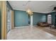 Living room featuring tile floors, sliding glass doors to the lanai, and neutral paint at 2300 Carpenter Ln, North Port, FL 34286