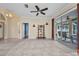 Open living area with ceramic tile flooring, neutral paint, and access to the enclosed patio at 2300 Carpenter Ln, North Port, FL 34286