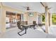 Covered patio with TV, ceiling fan and outdoor furniture at 2300 Carpenter Ln, North Port, FL 34286