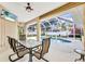 Enclosed outdoor pool with a table and chairs on the lanai, offering a relaxing and private space at 2300 Carpenter Ln, North Port, FL 34286