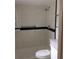 Bathroom features a walk-in shower, toilet, grab bar and black accent tiles at 23220 Rountree Ave, Port Charlotte, FL 33980